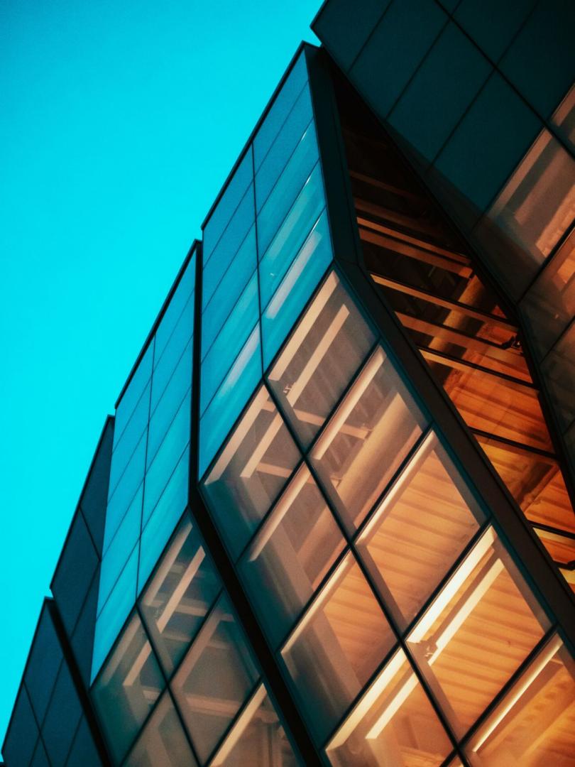 Modern angular glass facade at dusk